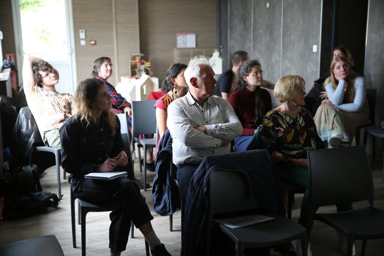 The group of patrons under discussion, seated on chairs.